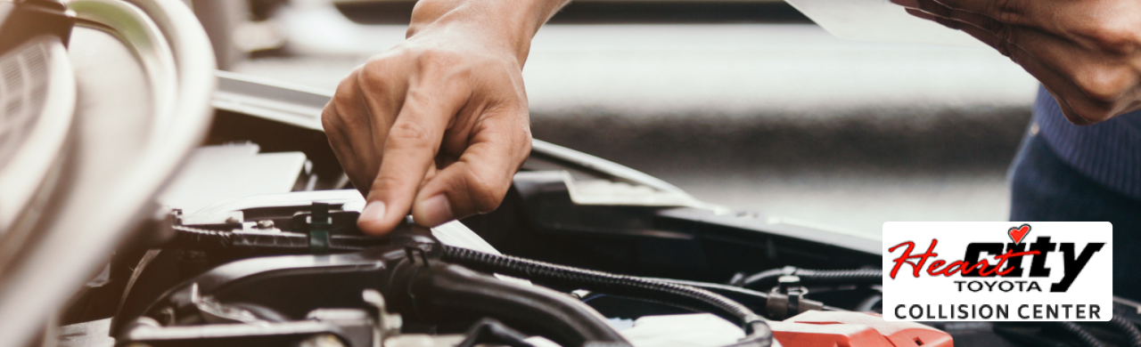 Technician inspecting vehicle frame at Heart City Toyota Collision Center in Elkhart, IN