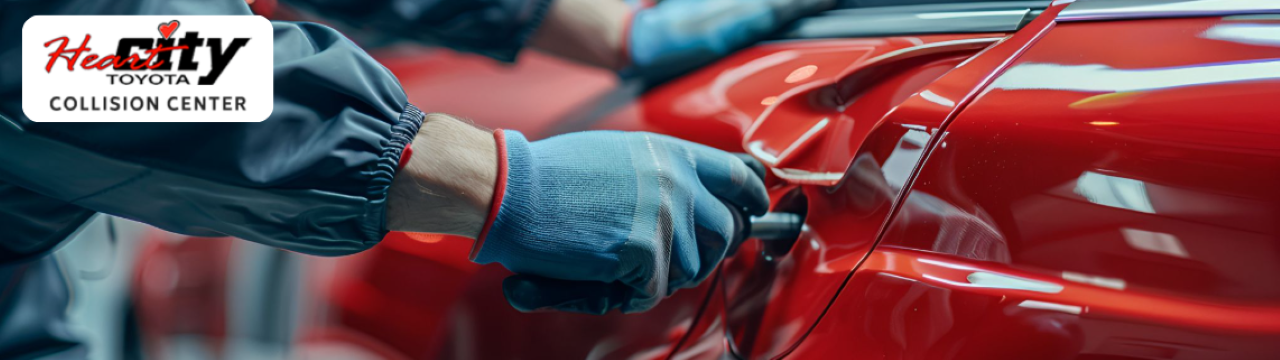 Technician performing paintless dent repair on a car at Heart City Toyota Collision Center in Elkhart, IN.