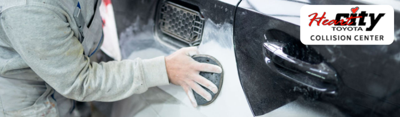 Auto body technician repairing a vehicle at Heart City Toyota Collision Center in Elkhart, IN.